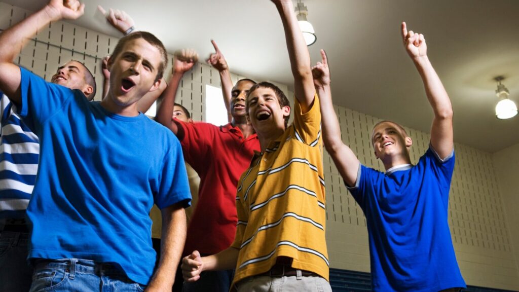 Group of teen boys stood, cheering all together - gender blog