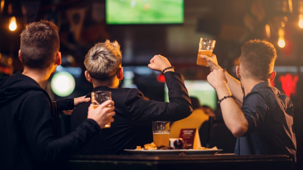 Group of three young men drinking in a bar
