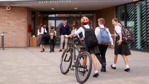 A group of young people arriving at school