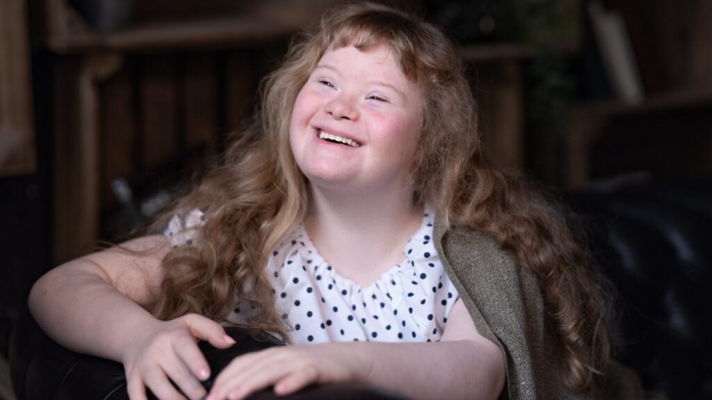 Girl with down-syndrome smiling into the distance