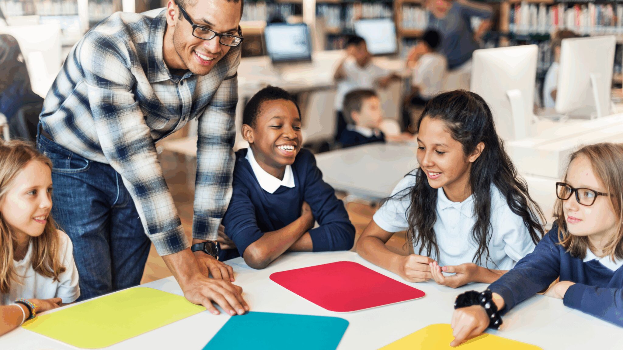 picture of a teacher talking to a table of students