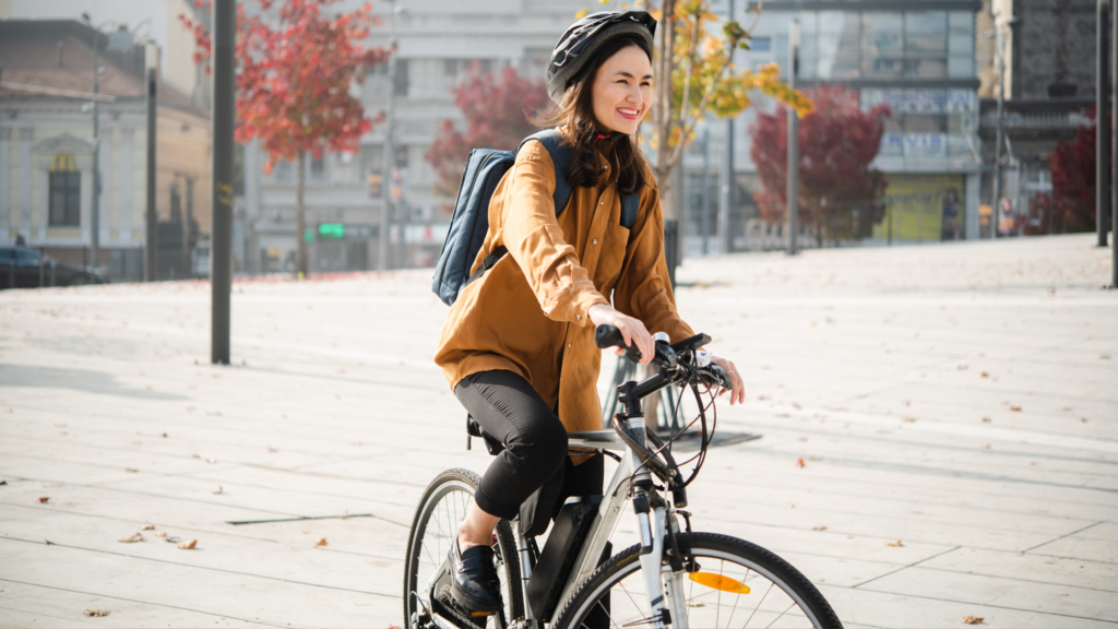 Lady cycling in road with helmet on
