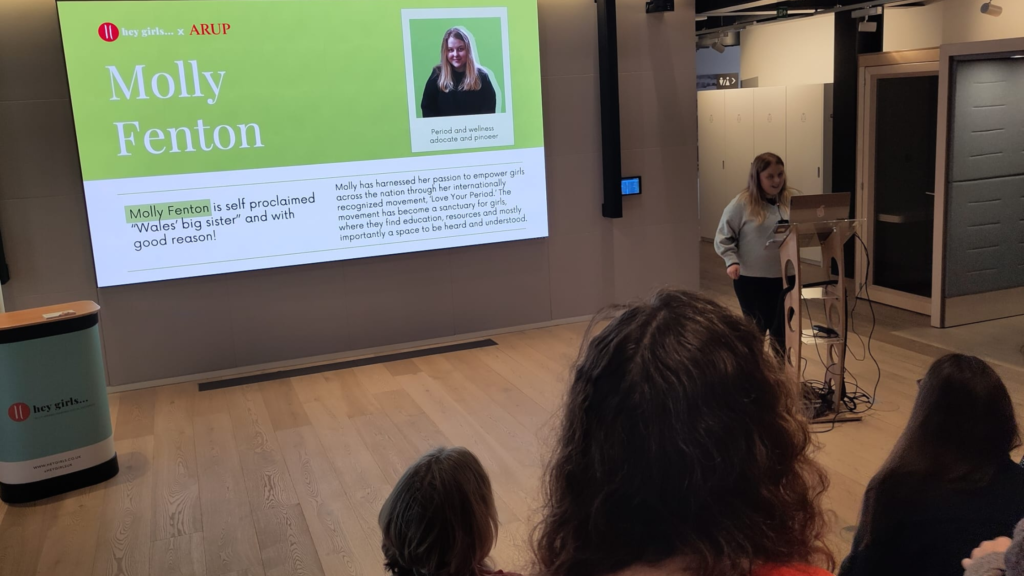 Molly Fenton giving a talk in a conference room