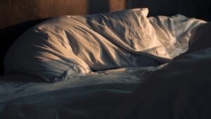 Pillow on an unmade, messy bed