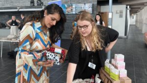 Molly Fenton, a young campaigner for the Love Your Period campaign, talking to a professional about period products