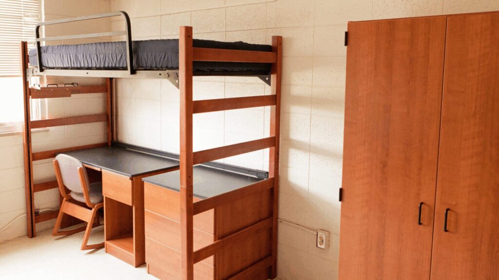 Singular dorm with raised bed, desk and wardrobe