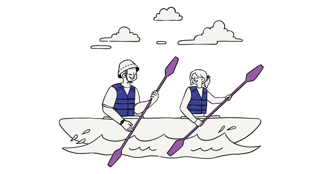 Two people kayaking on a river together, paddling with oars