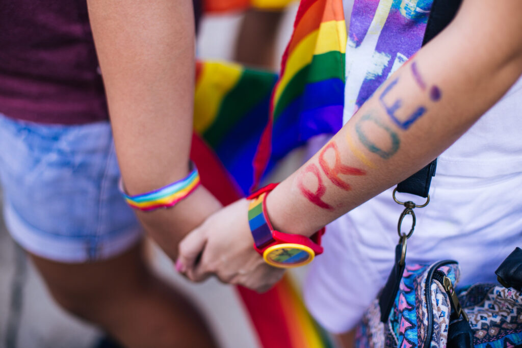 Two people holding hands at Pride